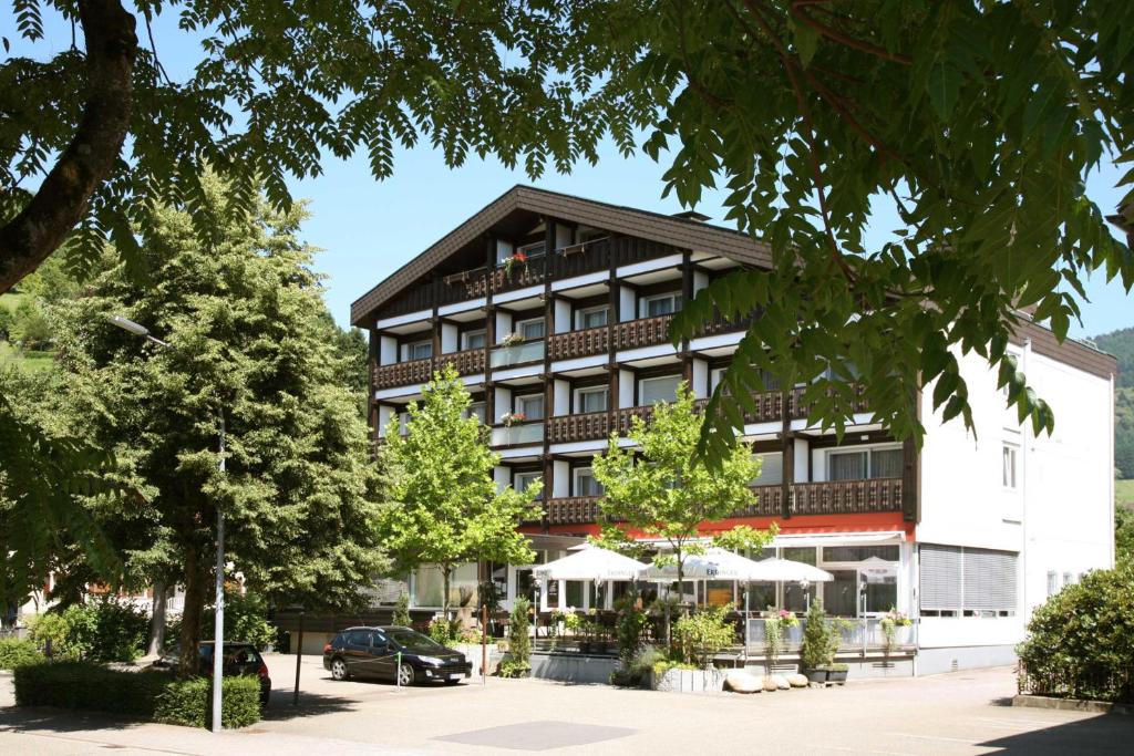a large building with trees in front of it at Hotel Pflug in Ottenhöfen