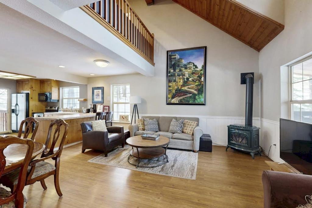 a living room with a couch and a fireplace at Tranquil cabin near ski slopes & trails with wraparound deck & pool table in Truckee