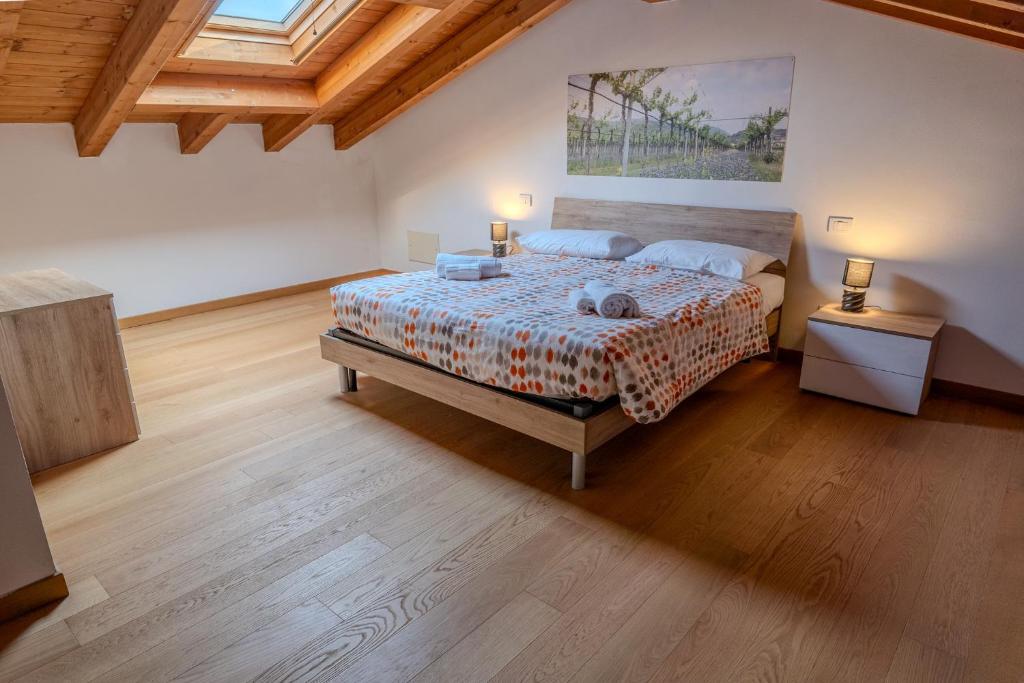 a large bedroom with a bed and a wooden floor at Relais Terre Divino 1 in Ponton