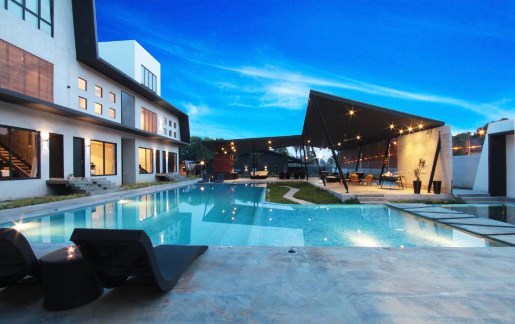 a swimming pool in front of a building at night at Villa Lot 1638 in Port Dickson