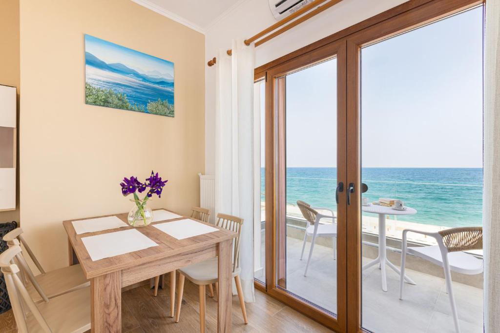a dining room with a table and a view of the ocean at Azzure Studio in Kokkari