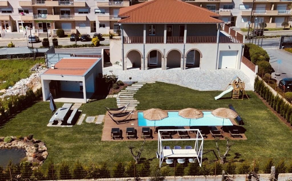 an aerial view of a house with a swimming pool at Solar dos Arcos • Luxury Rural Retreat & Heated Po in Macieira da Lixa