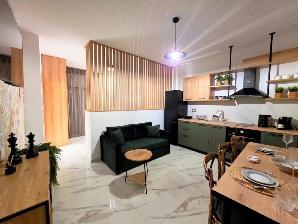 a kitchen and living room with a couch and a table at Anthouli Homes 1, steps from beach and centre in Kardamaina