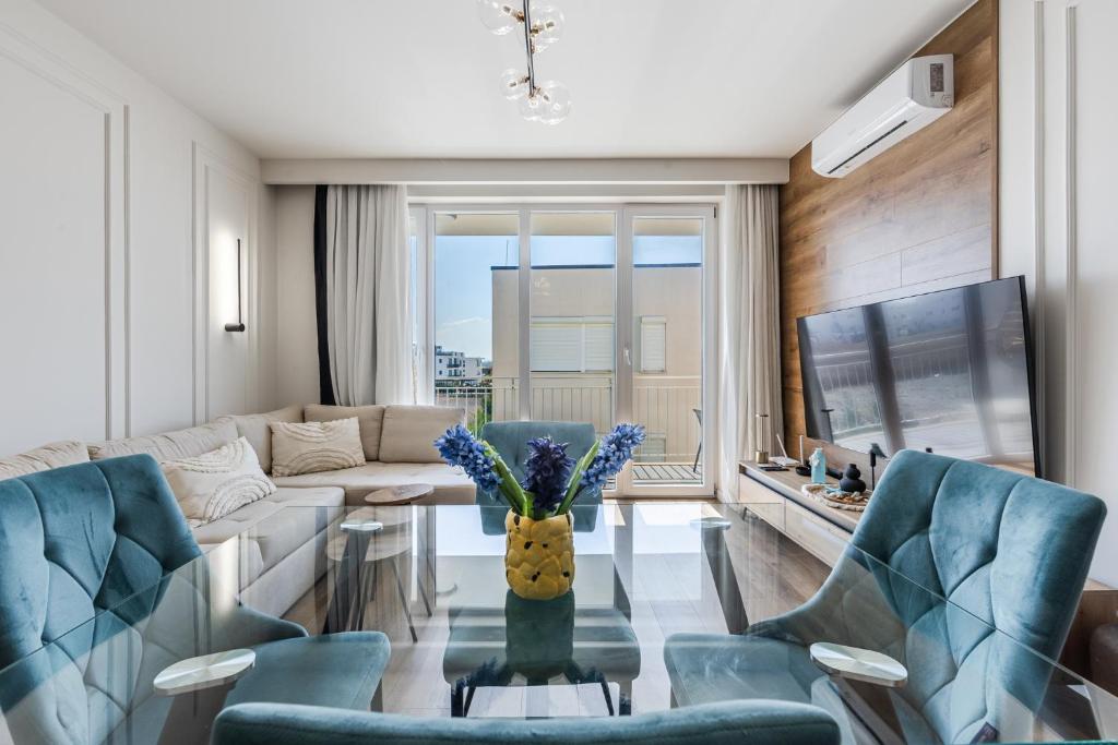 a living room with a couch and a table at Talea Elegant Escape by PikHost in Lezhë
