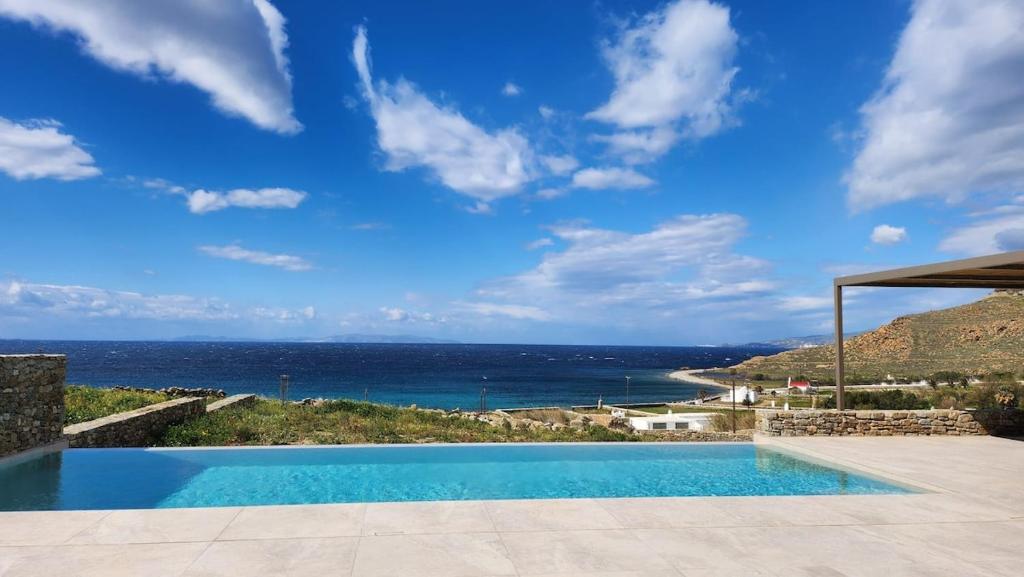 a swimming pool with a view of the ocean at Fenia's Paradise Villa in Houlakia