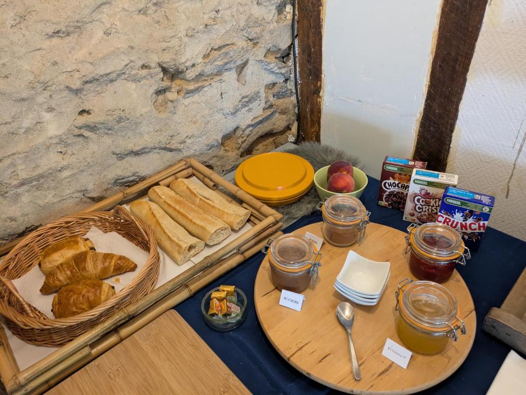 a table with a tray of bread and a basket of bread at Bus magique avec tente glamping in Saint-Palais