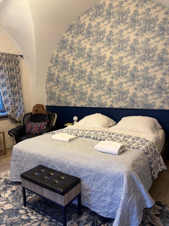 a bedroom with a large bed with a wall mural at Apartmán No 244 in Tábor