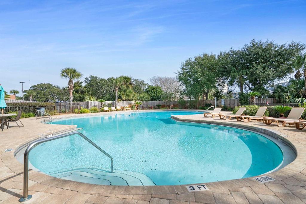 a large swimming pool with chairs around it at Pirates Bay B215 in Fort Walton Beach