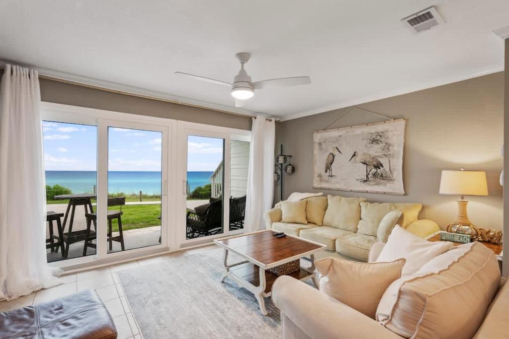 a living room with a couch and a table at Blue Tide #8A in Seacrest