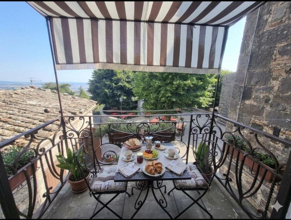 a table with food on top of a balcony at Borgo Maggiore in Radicofani