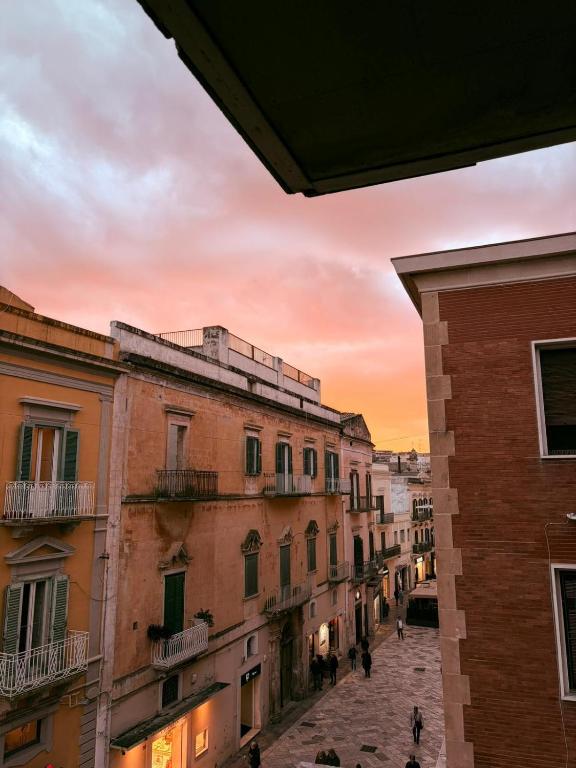 a view of a city street at sunset at 1402 Rooms in Matera