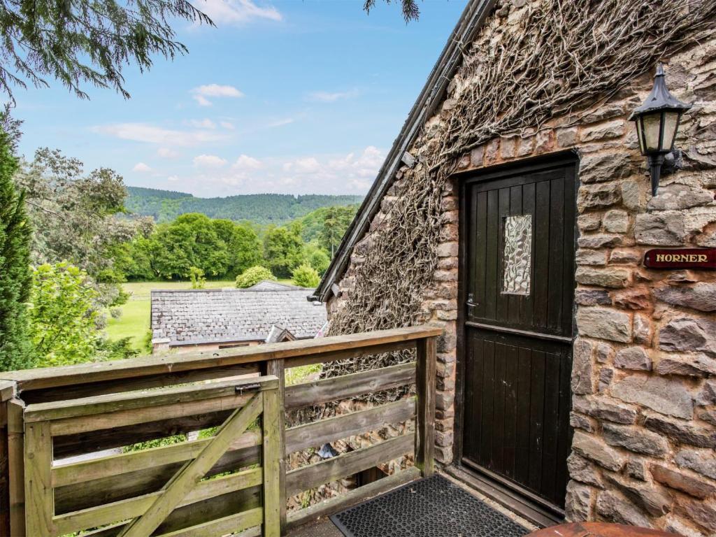 a barn with a wooden door and a fence at Horner- Ukc4923 in Timberscombe