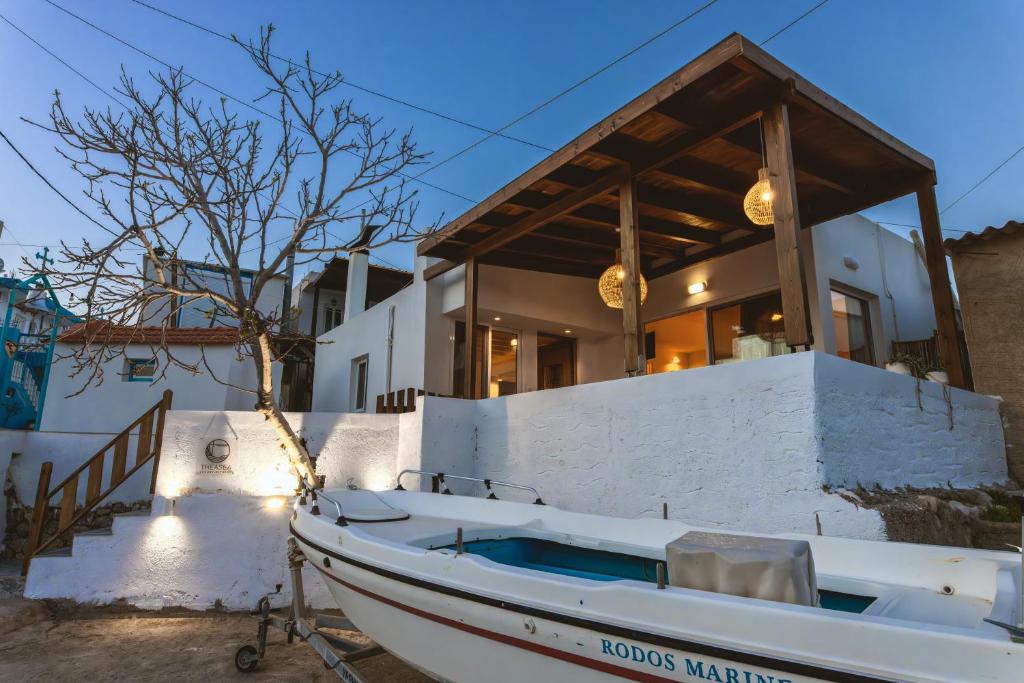 a boat parked in front of a house at Theasea luxury retreat in Vrachonisída touArchangélou