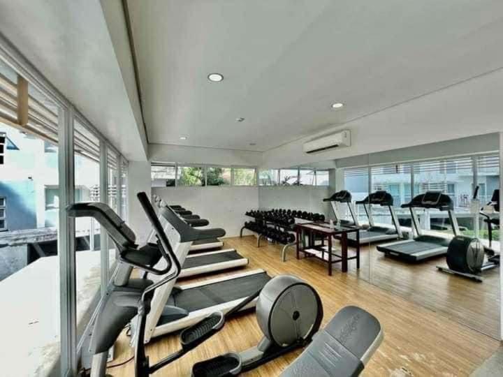 a gym with a bunch of exercise equipment in it at Cozy unit in mivesa garden residence in Cebu City