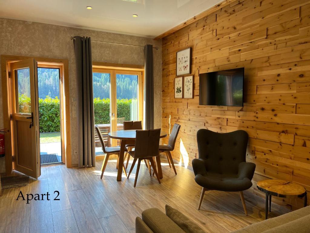 a dining room with a table and chairs at Alpenburg Bergparadies Apartments in Wald am Arlberg
