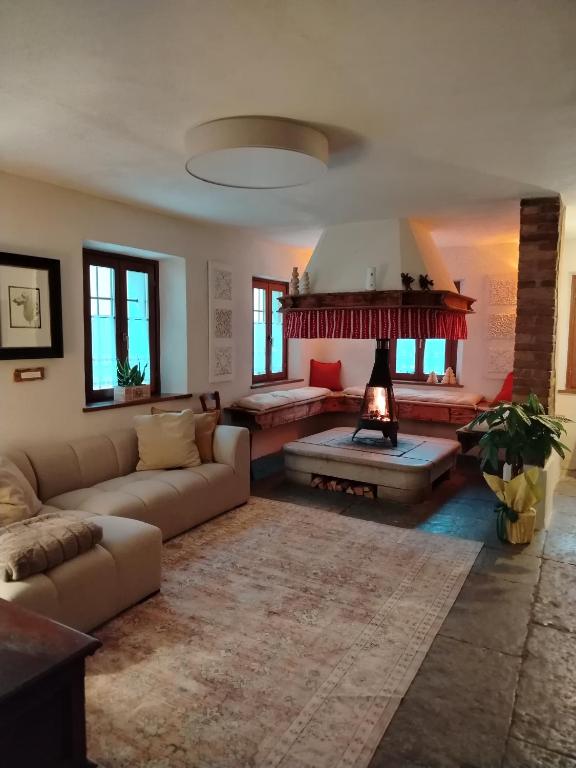a living room with a couch and a fireplace at La Casa dei Ricordi in Igne