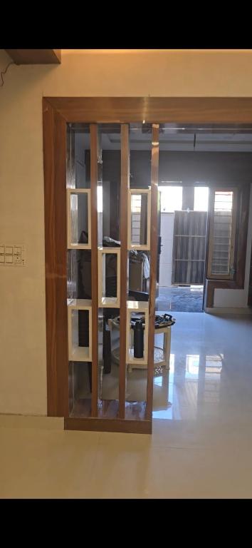 a glass cabinet in a room with a microwave at RYIZ Villa in Agra