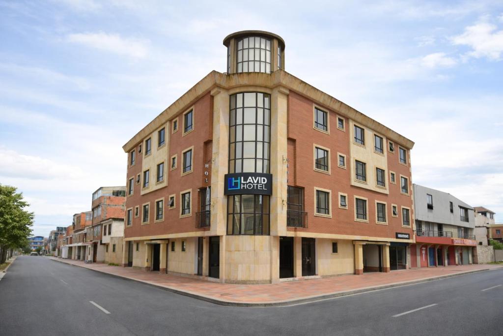 a large brick building on the side of a street at Lavid Hotel Kennedy in Bogotá