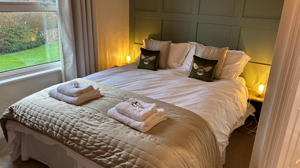 a bedroom with a large bed with towels on it at Jack & Jill Inn Pub in Hassocks