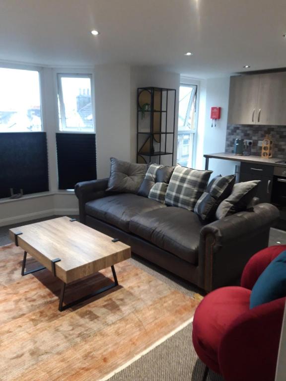 a living room with a couch and a coffee table at Morecambes wise place in Morecambe