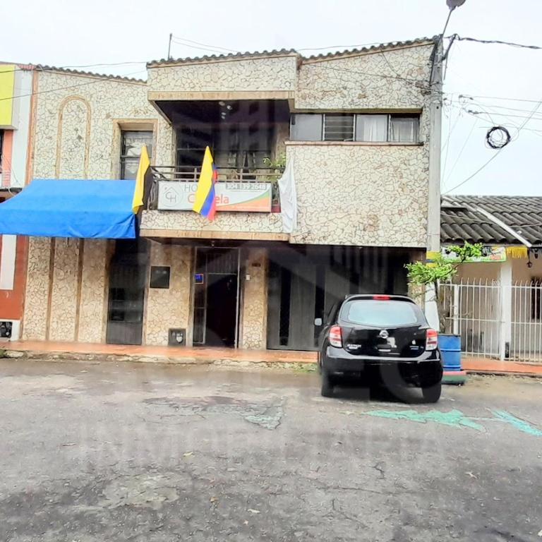 a car parked in a parking lot in front of a building at Hospedaje Chavela in Barrancabermeja