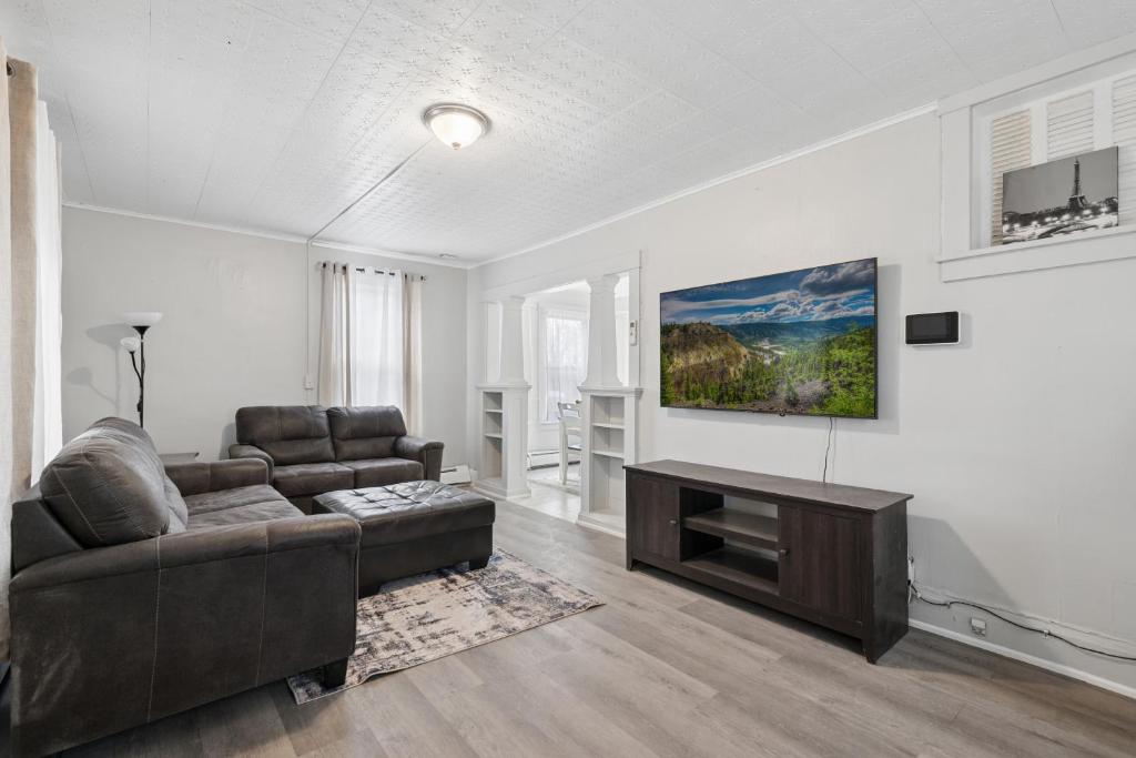 a living room with a couch and a table at Home In Highland Park in Saint Paul