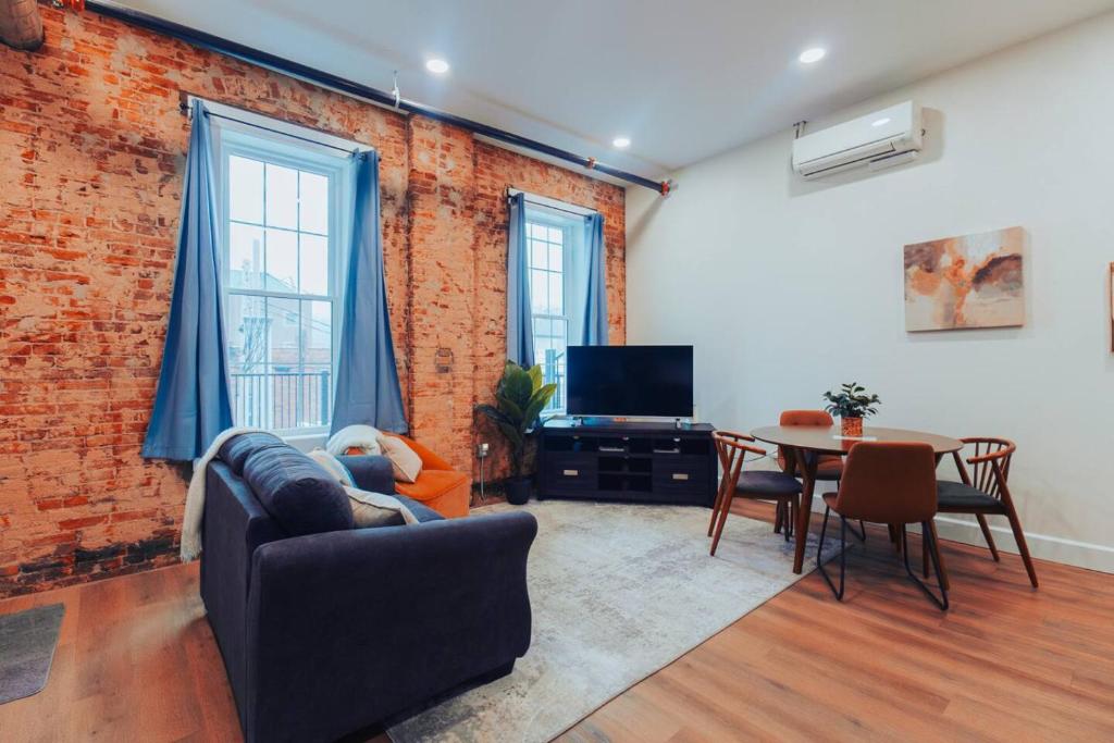 a living room with a couch and a table at American Hall - Young Suite in Millersburg