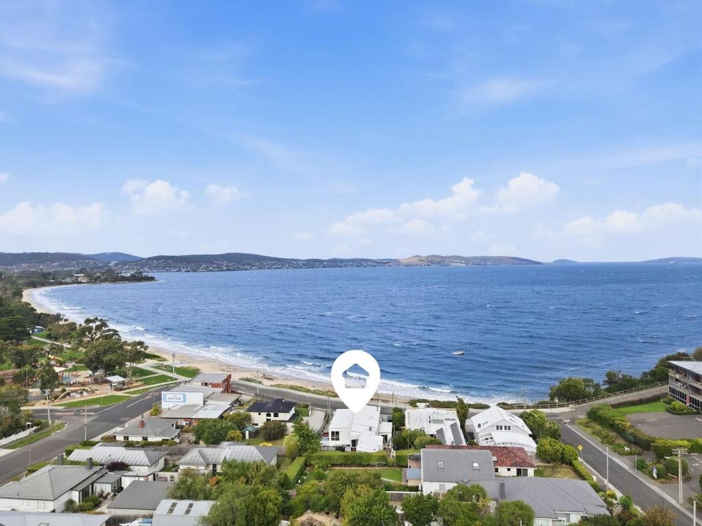 an aerial view of a beach with houses and the ocean at Beachfront Beauty Bellerive in Bellerive
