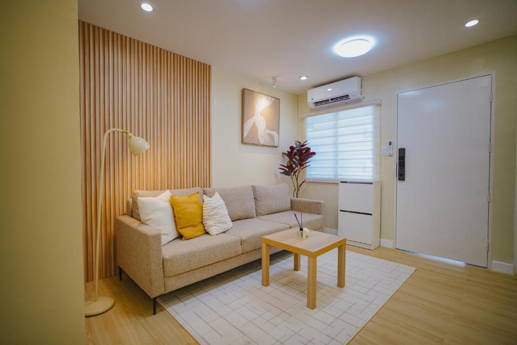 a living room with a couch and a table at Silid Pahingahan at Forest Residences in Antipolo