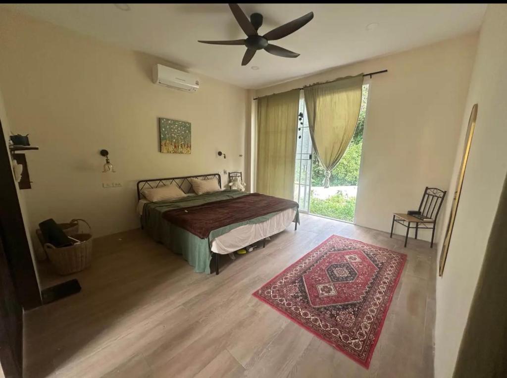 a bedroom with a bed and a ceiling fan at Baan kratay in Chaloklum