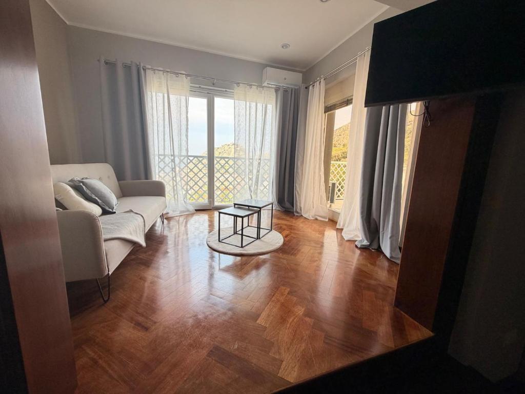 a living room with a couch and a table at thalore room e apartments in Amantea
