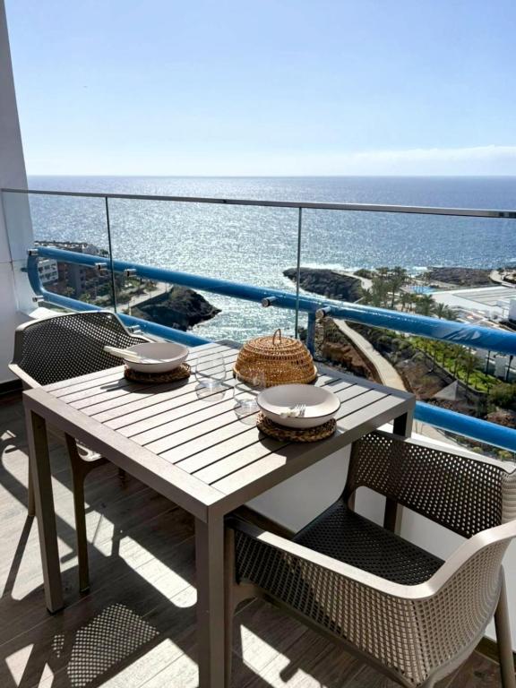 a table on a balcony with a view of the ocean at Sanmarcos in Playa Paraiso