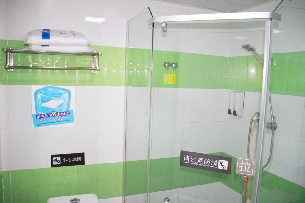 a shower with a glass door in a bathroom at 7Days Inn Beijing Jiugong in Daxing