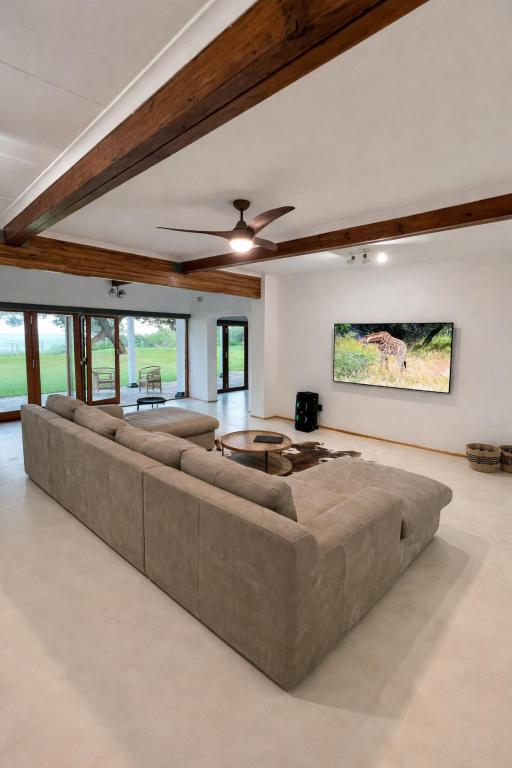 a large living room with a large couch at Berna Coastal Retreat in Port Shepstone