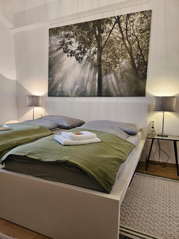 a bedroom with a bed with a painting on the wall at ANKU's in Krems an der Donau