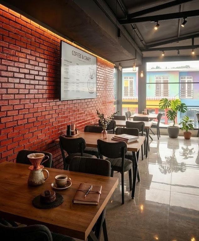 a restaurant with tables and chairs and a brick wall at Mustafa Hotel Restaurant in Pamukkale