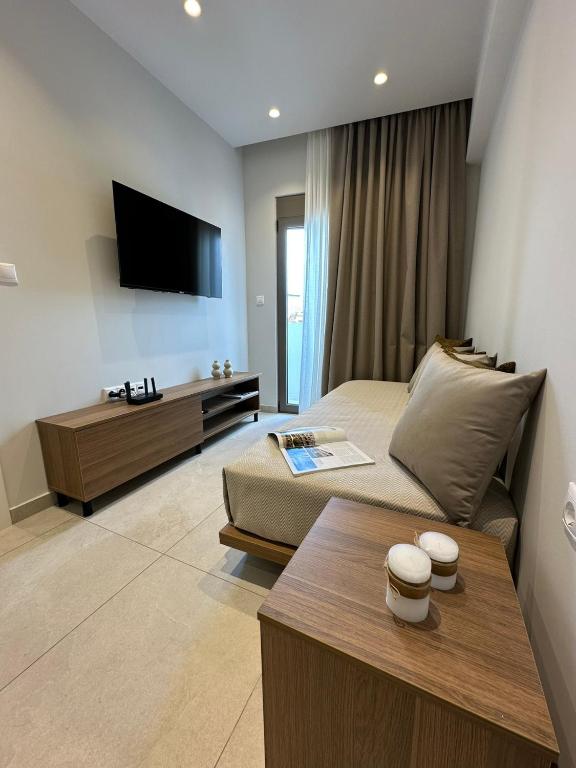 a living room with a bed and a tv at 2BR Apartment for 5 in Archangelos Rhodes with Parking - Equus Sky in Archangelos