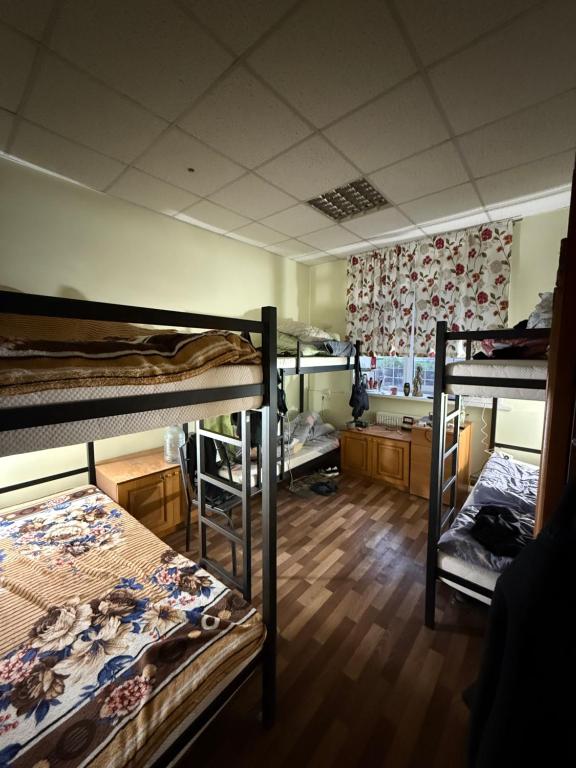 a room with three bunk beds in it at Хостел San in Kamianske