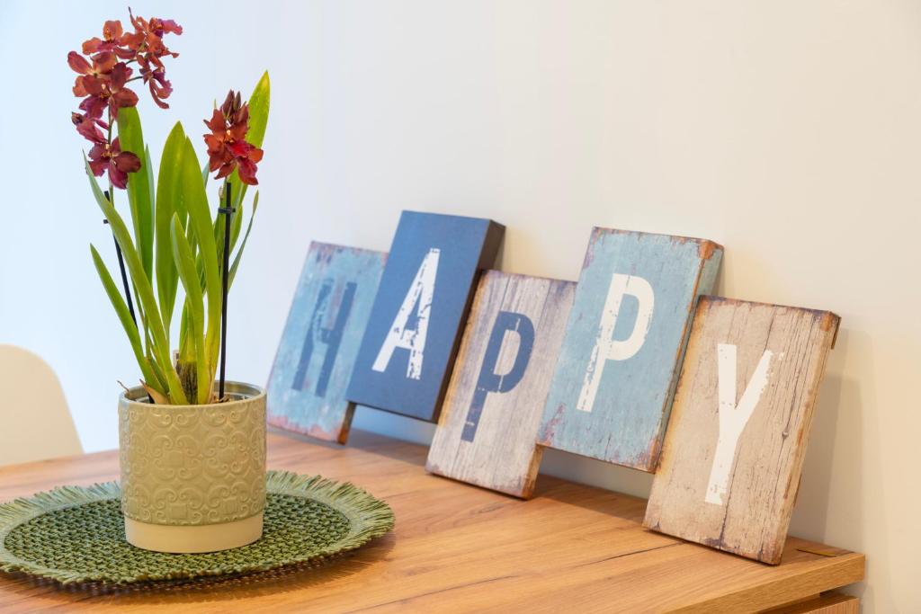 a table with some flowers in a vase and some signs at Leiria Boutique Apartment in Leiria
