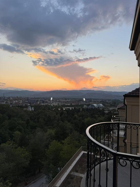 a view of a city at sunset from a balcony at Vila 76 Belvedere in Korçë