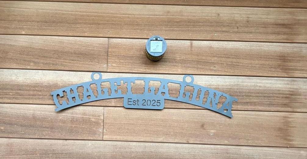 a blue clock sitting on top of a wooden fence at La Luna in Lanaken