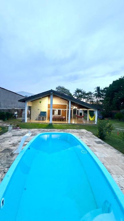 a house with a swimming pool in front of it at Chácara Paraíso do Mar - Araçagi in São José de Ribamar