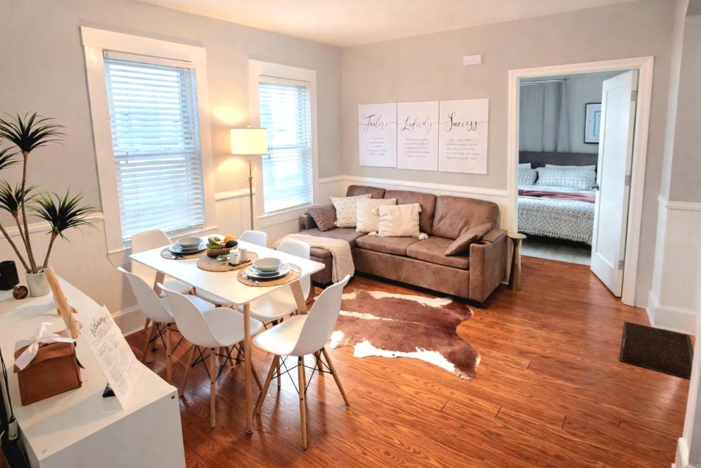 a living room with a couch and a table at Luxe 3BR Apartment at MIT Harvard with FREE parking in Cambridge