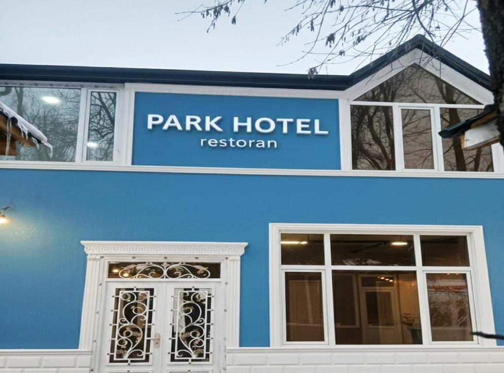 a blue building with a park hotel resort sign at Park Hotel in Quba