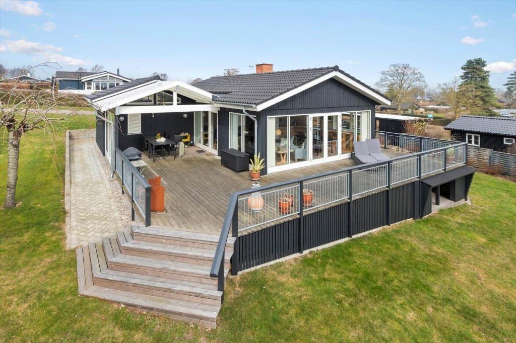 a home with a large deck and a house at 30472-Odder-Ravnsager-20 in Dyngby