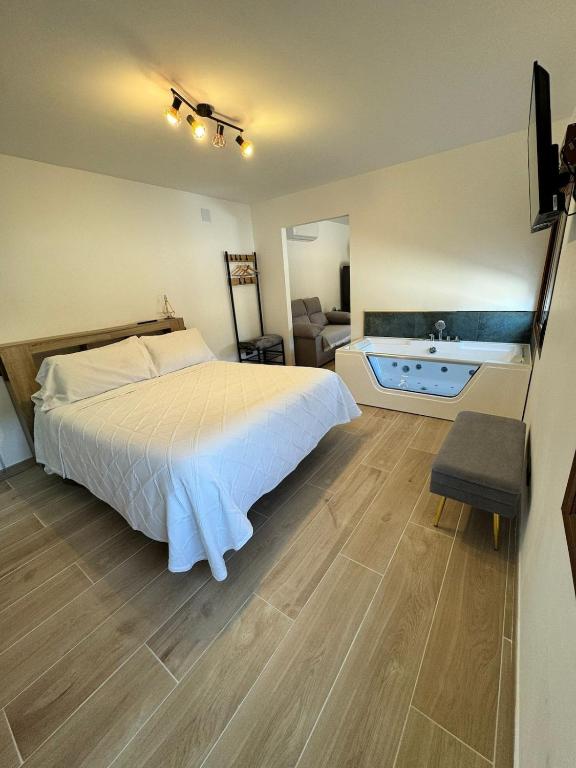 a bedroom with a bed and a tub in it at Verde in Alcalá del Júcar