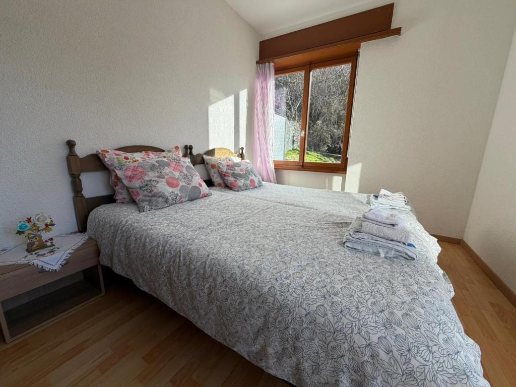 a bedroom with a bed and a window at La Pergola in Auressio