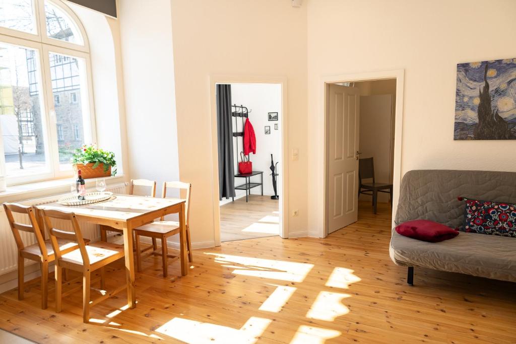 a living room with a table and a couch at Ferienwohnung am Kirchplatz in der Altstadt in Rinteln