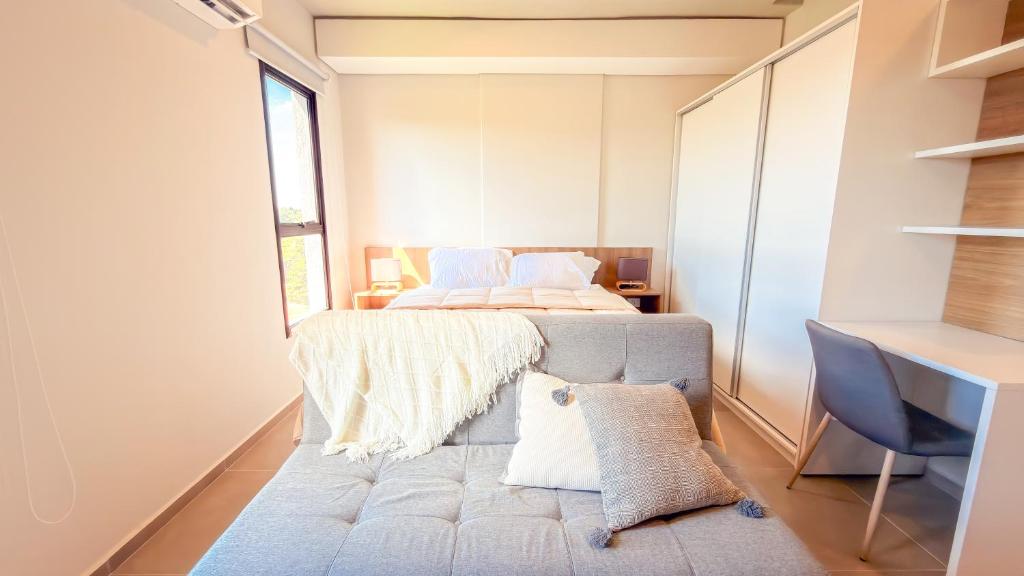a bedroom with a bed and a desk and a window at Civis Jardinia Sky Studio 4B Pool & Sauna in Luque