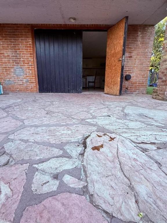a building with a door and a stone patio at Le de nery in Ostende